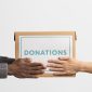 volunteer giving box with donations another volunteer 85x85